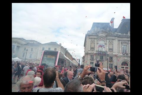 Rose petals flutter over Place Jean-Jaurès during the inaugration ceremony.